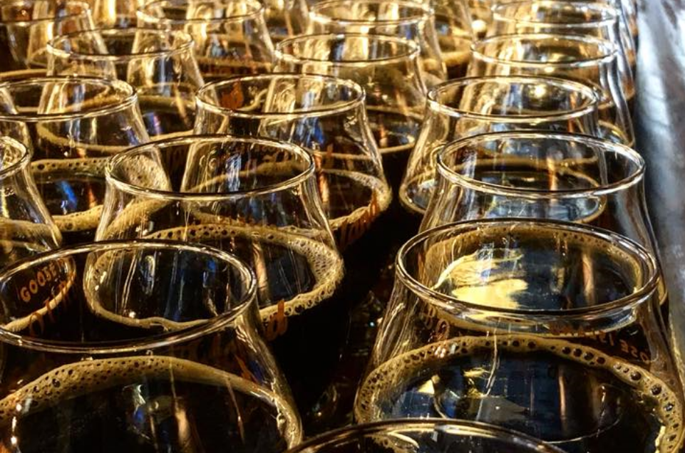 Image of many glasses of beer brewed at the Rock Island Brewing Company lined up and ready for serving